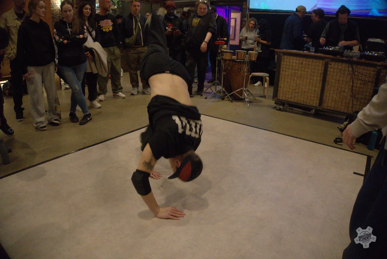 Performer balancing on one hand during an Industrial Elements event